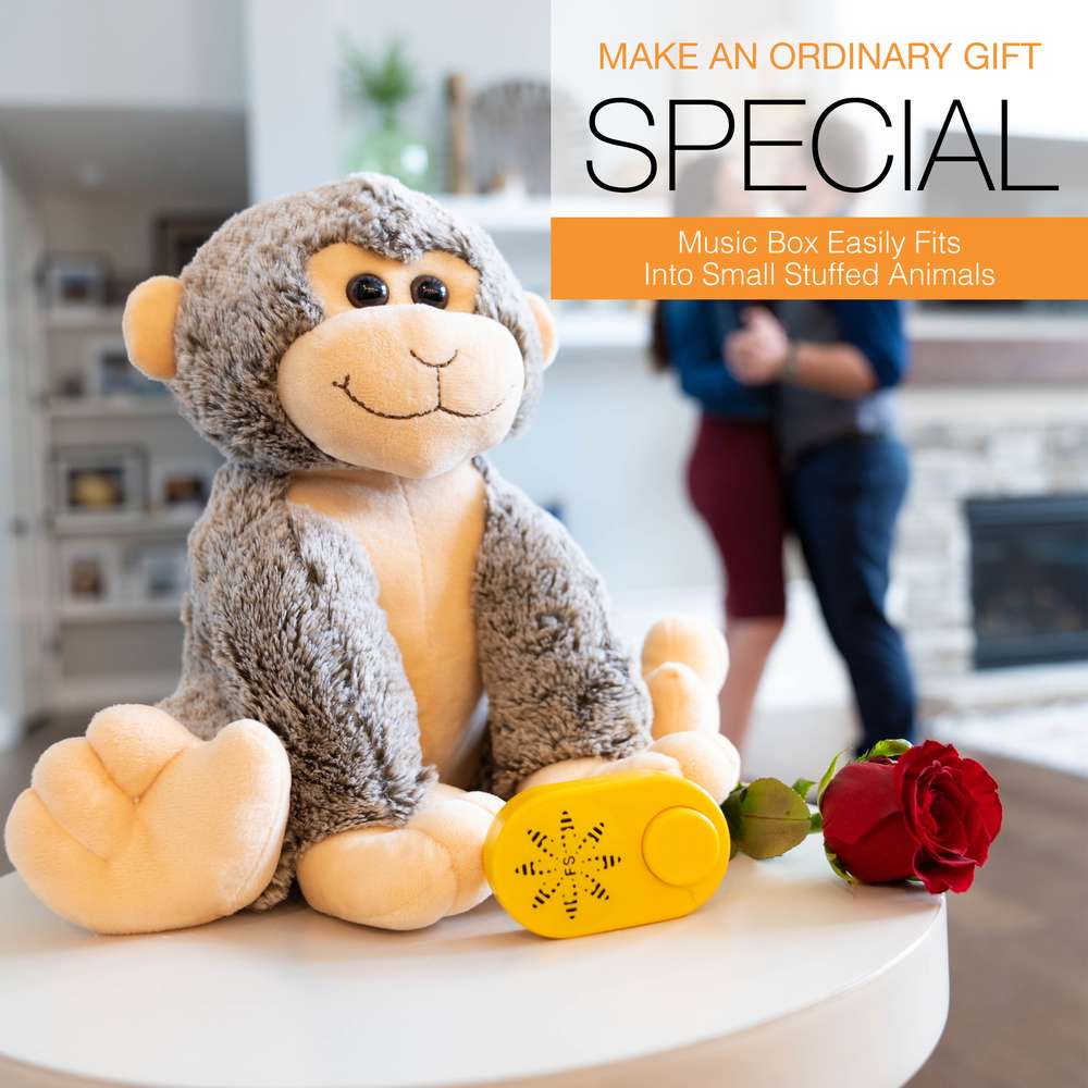a soft toy monkey with yellow music box and a rose 
