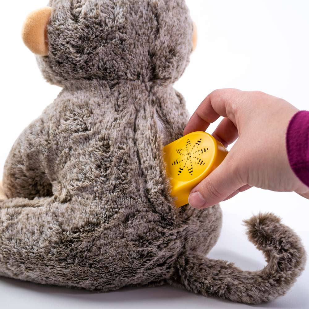 a girl putting music box inside a soft toy