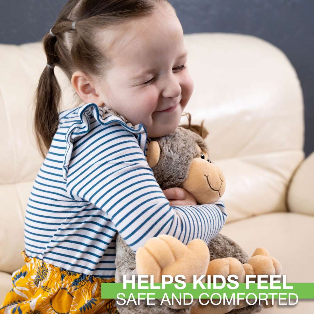 a little girl hugging a soft toy